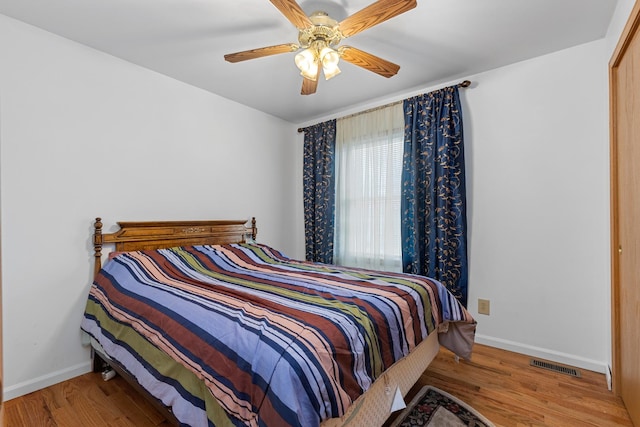 bedroom featuring wood-type flooring and ceiling fan