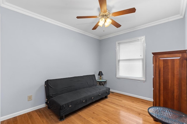 living area featuring crown molding, ceiling fan, and light wood-type flooring