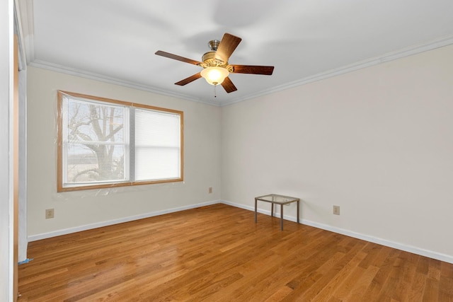 empty room featuring ornamental molding, light hardwood / wood-style floors, and ceiling fan