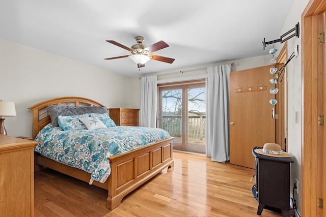 bedroom with ceiling fan, access to exterior, and light wood-type flooring