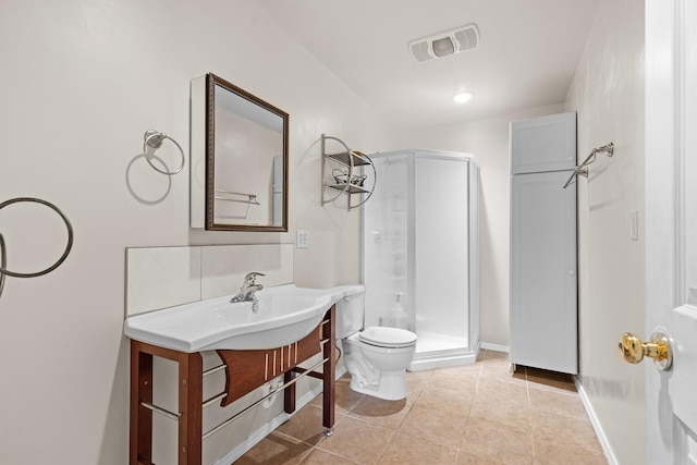 bathroom featuring sink, tile patterned floors, toilet, and a shower with door