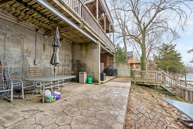 view of patio with a grill and a deck