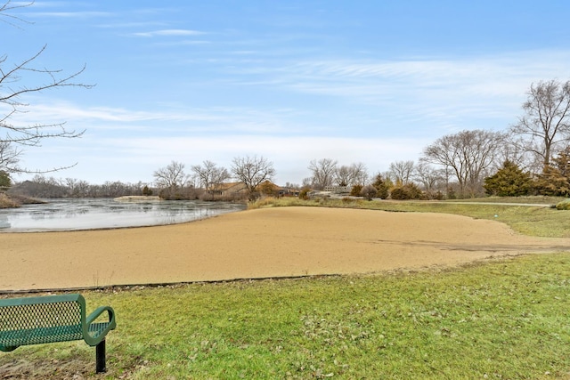 view of home's community featuring a water view and a yard