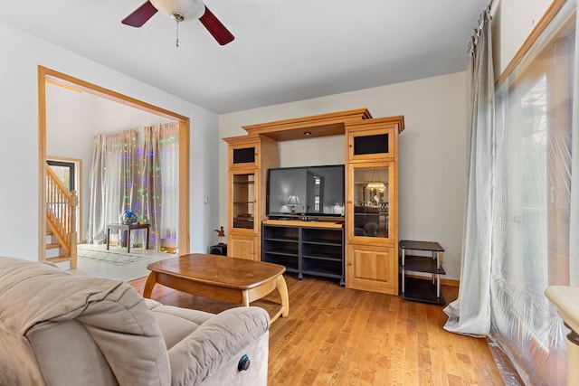 living room featuring ceiling fan and light wood-type flooring