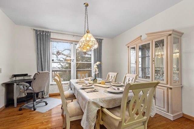 dining area featuring hardwood / wood-style floors and a chandelier