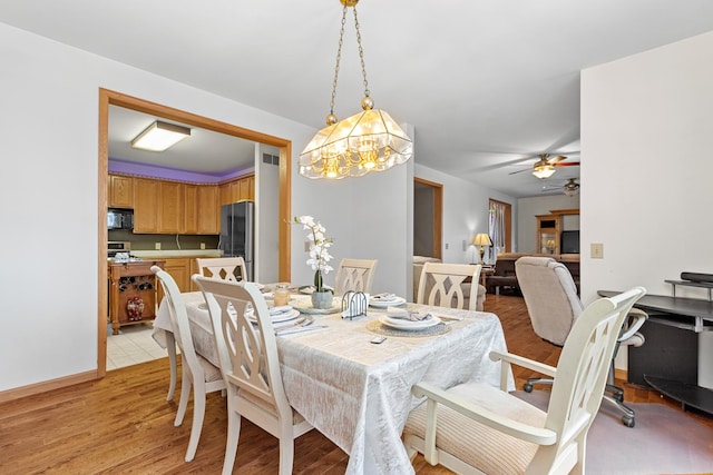 dining area with ceiling fan and light wood-type flooring