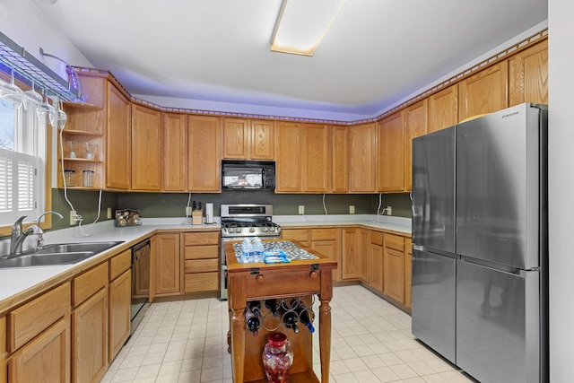 kitchen featuring a center island, sink, light tile patterned floors, and black appliances