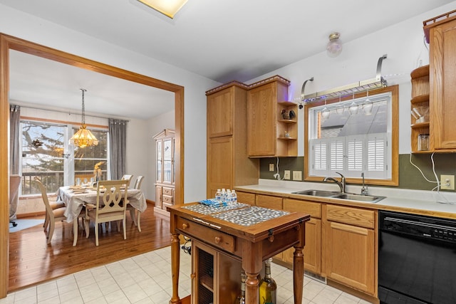 kitchen with a healthy amount of sunlight, dishwasher, sink, and hanging light fixtures