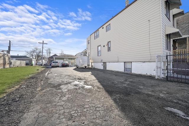 view of side of home featuring a garage and a yard