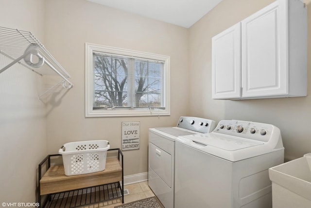 laundry area with cabinets, light tile patterned flooring, washer and dryer, and sink