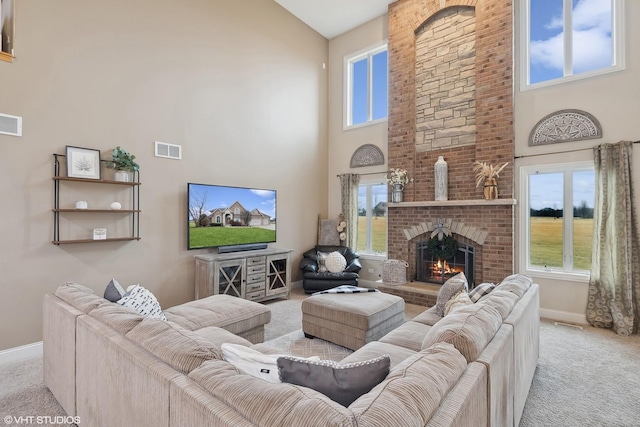 carpeted living room with a towering ceiling and a fireplace