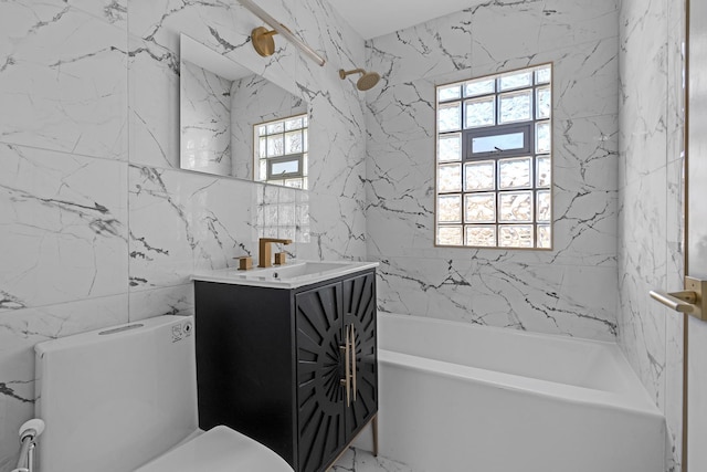 full bathroom with vanity, tile walls, washtub / shower combination, and toilet