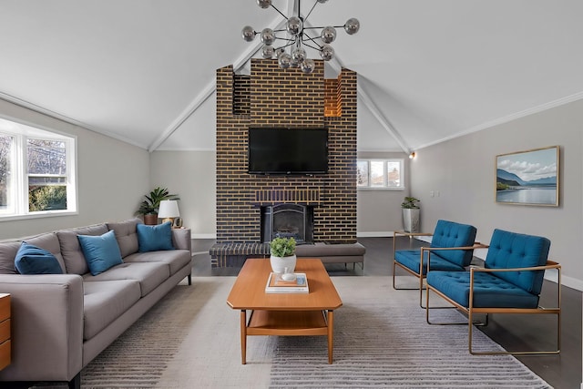 living room featuring vaulted ceiling, a healthy amount of sunlight, and a fireplace