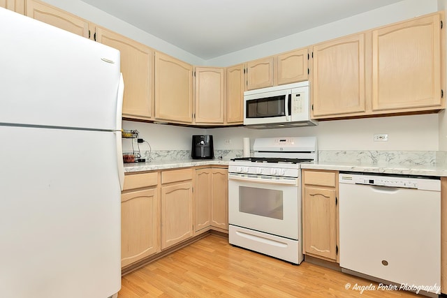 kitchen featuring white appliances, light wood-type flooring, and light brown cabinets