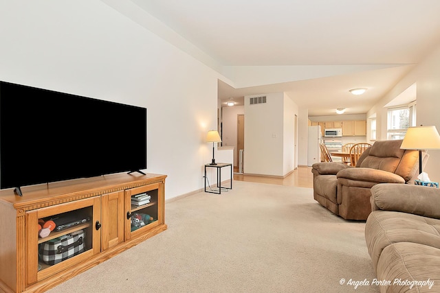 carpeted living room featuring lofted ceiling