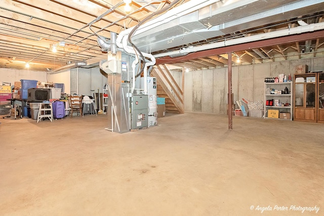 basement featuring heating unit and water heater