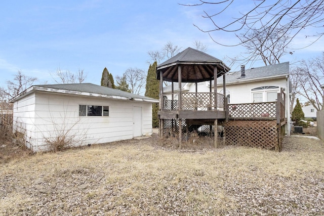 rear view of house with a wooden deck and a gazebo