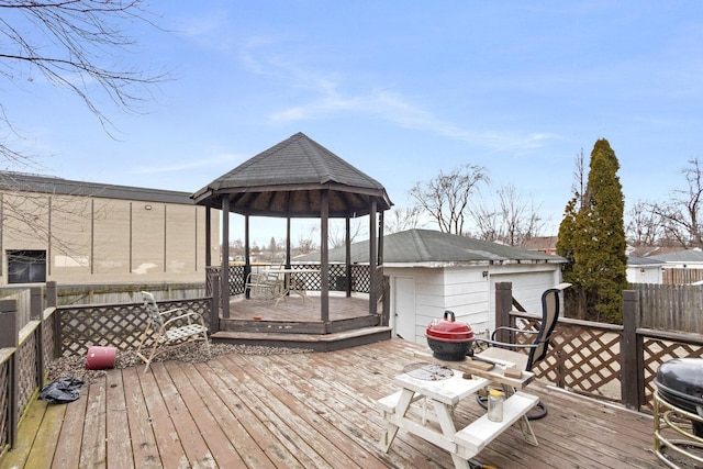 wooden deck featuring a gazebo and a grill