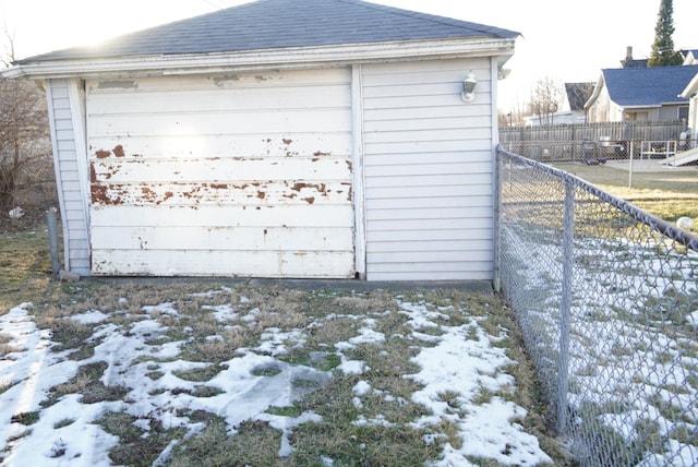 snow covered structure with a garage