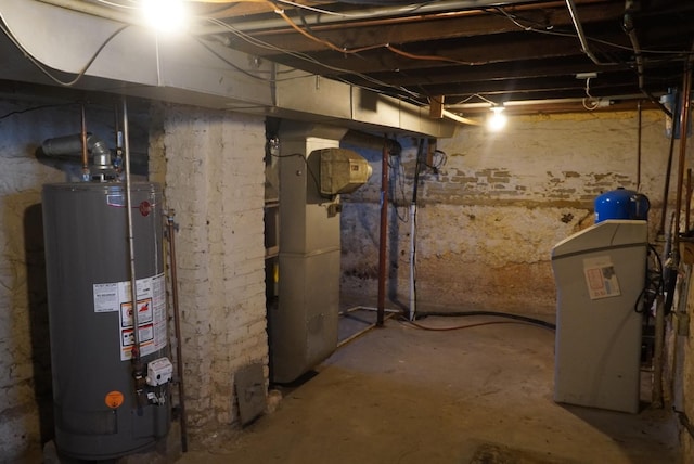 basement featuring heating unit and water heater