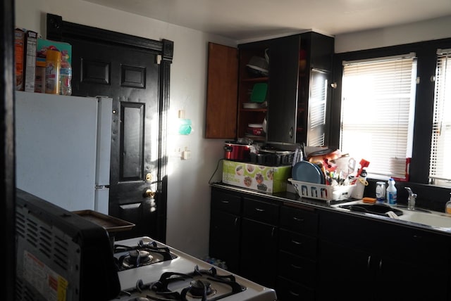 kitchen featuring white appliances and sink