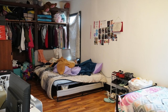 bedroom featuring wood-type flooring and a closet