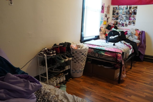 bedroom with dark hardwood / wood-style flooring