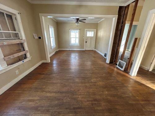 entrance foyer with ornamental molding, dark wood-type flooring, and ceiling fan