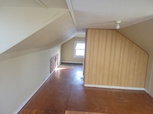 additional living space with vaulted ceiling