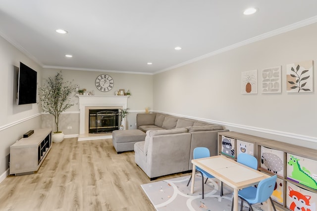 living room featuring ornamental molding and light hardwood / wood-style floors