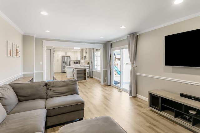 living room with crown molding and light wood-type flooring