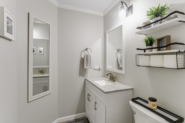 bathroom featuring vanity, ornamental molding, and toilet