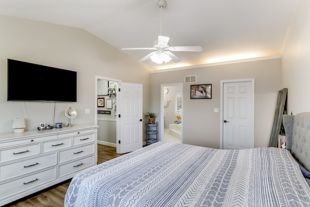 bedroom with lofted ceiling, dark hardwood / wood-style floors, ceiling fan, and ensuite bathroom