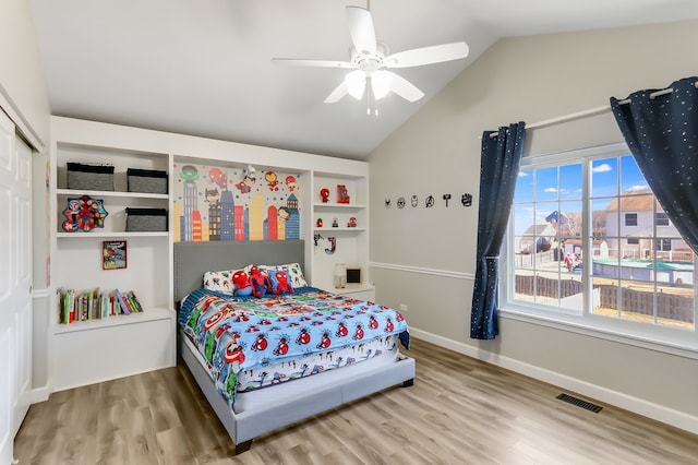 bedroom featuring a closet, ceiling fan, vaulted ceiling, and hardwood / wood-style floors