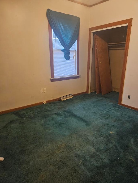 unfurnished bedroom with carpet and a closet