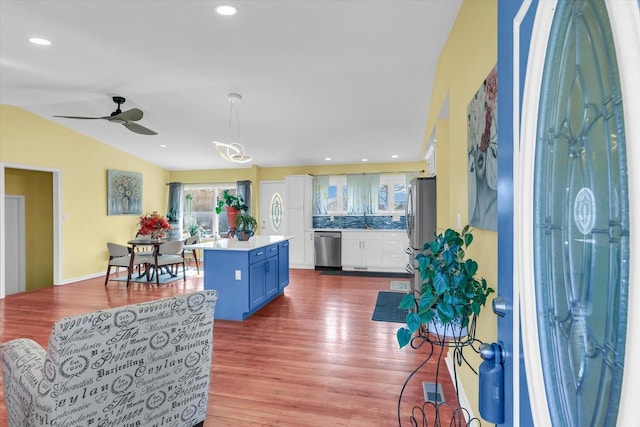 foyer entrance featuring lofted ceiling, sink, hardwood / wood-style flooring, and ceiling fan