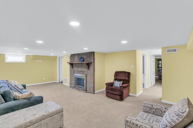 living room featuring light carpet and a fireplace