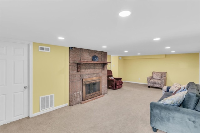 living room featuring a brick fireplace and light carpet