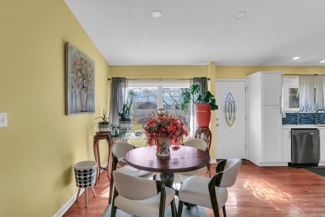 dining space with wood-type flooring