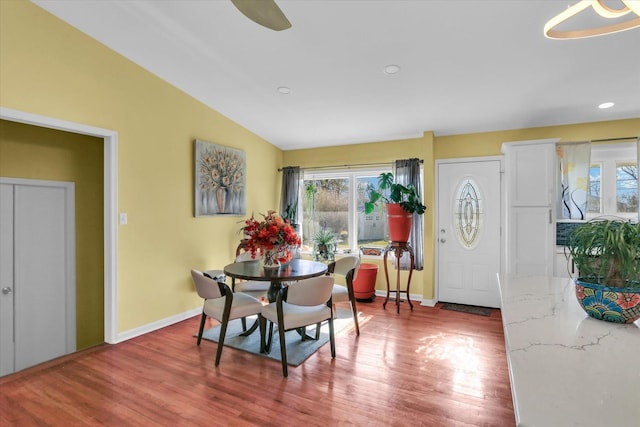 dining area featuring hardwood / wood-style flooring, ceiling fan, and lofted ceiling