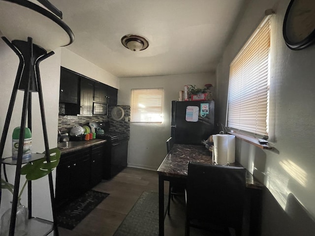 kitchen with tasteful backsplash, dark hardwood / wood-style floors, and black appliances