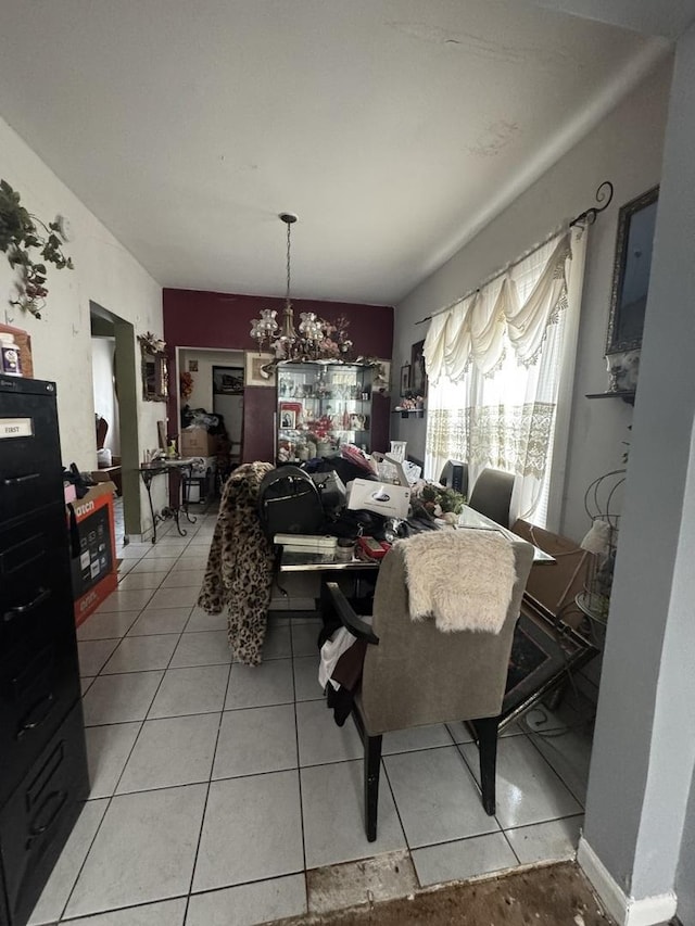 dining area with light tile patterned flooring and a notable chandelier