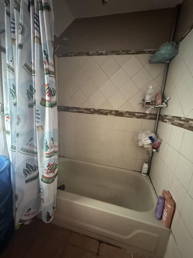 bathroom with tile patterned flooring and shower / tub combo