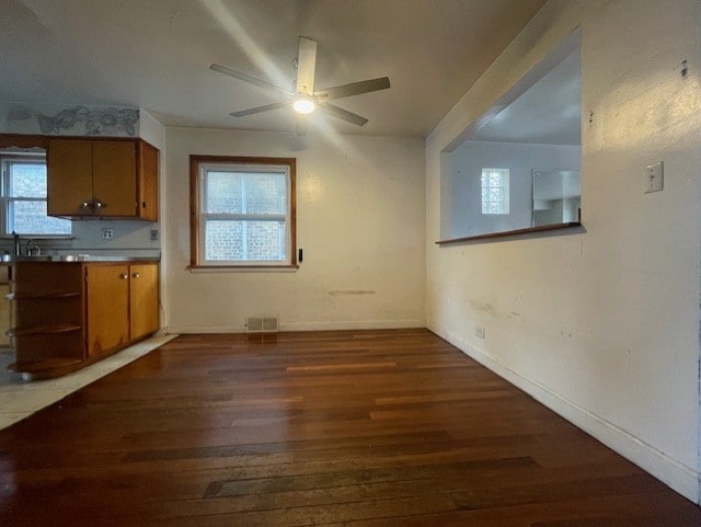 kitchen with dark hardwood / wood-style floors, sink, and ceiling fan