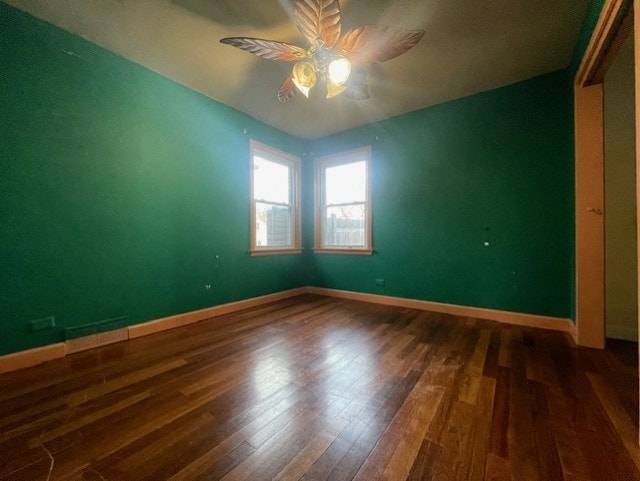 unfurnished bedroom featuring dark hardwood / wood-style floors and ceiling fan