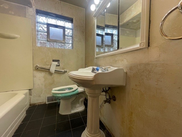 bathroom with tile patterned floors and toilet