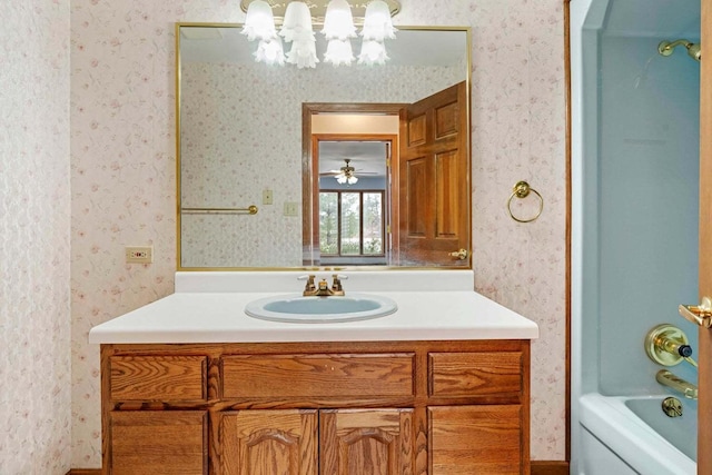 bathroom with washtub / shower combination and vanity