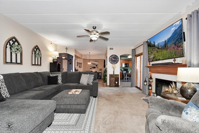 living room featuring carpet flooring and ceiling fan