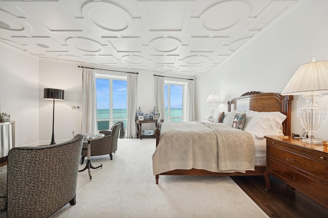 bedroom with wood-type flooring and a water view