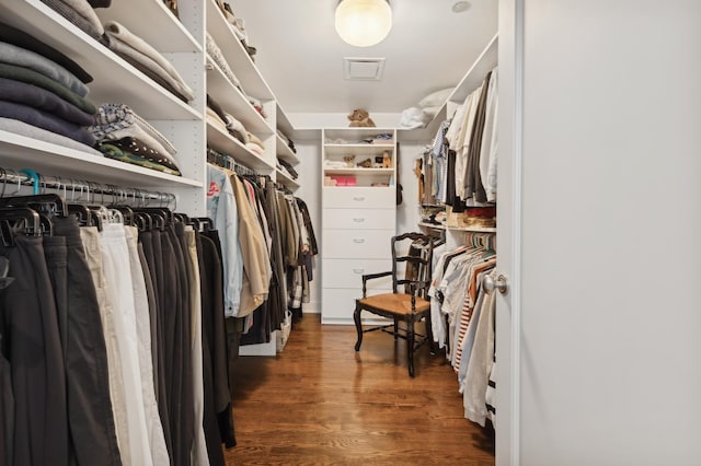 walk in closet with dark hardwood / wood-style flooring